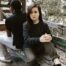 two people sitting with their backs to each other signifying boundaries